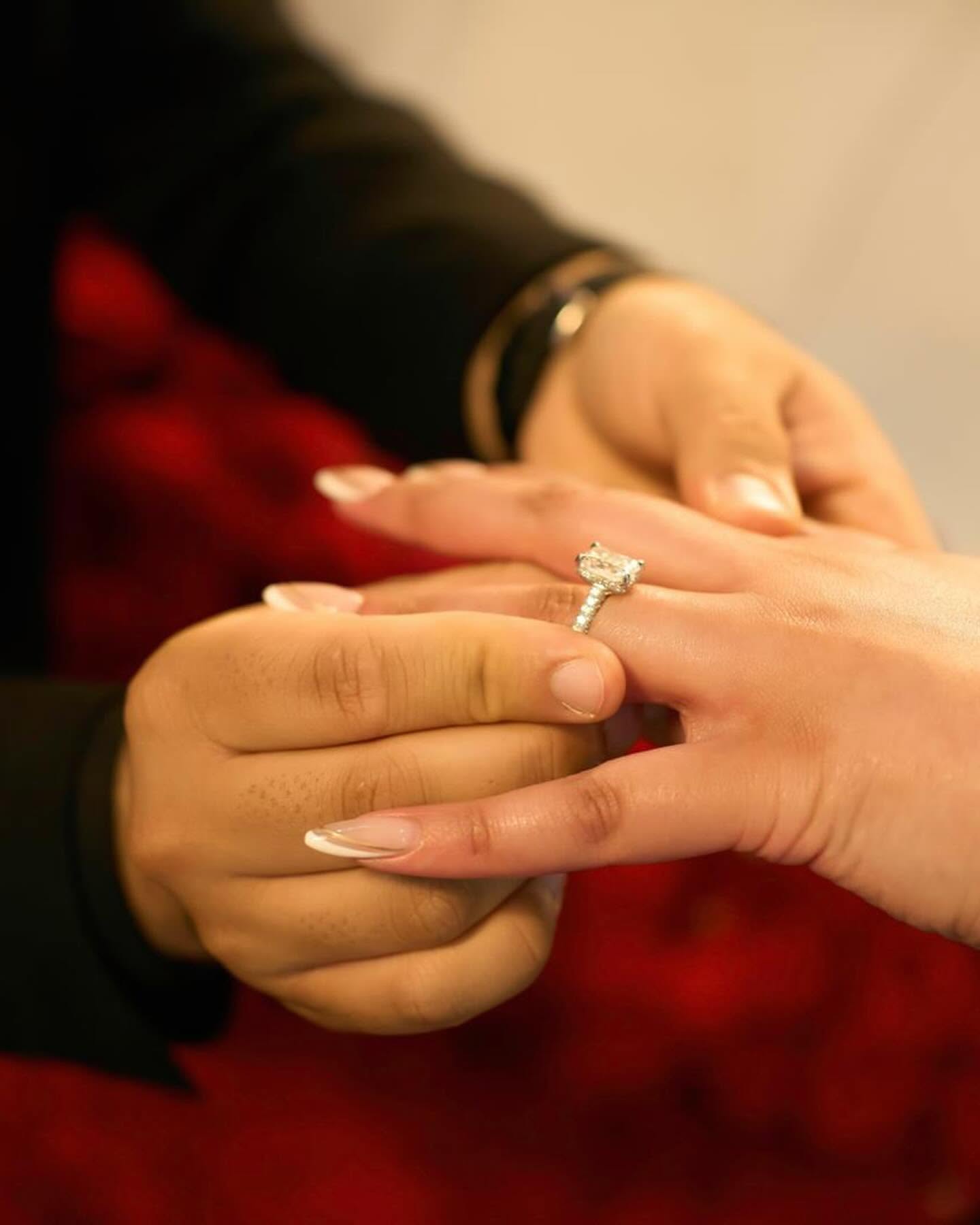 An engagement ring held up during a proposal